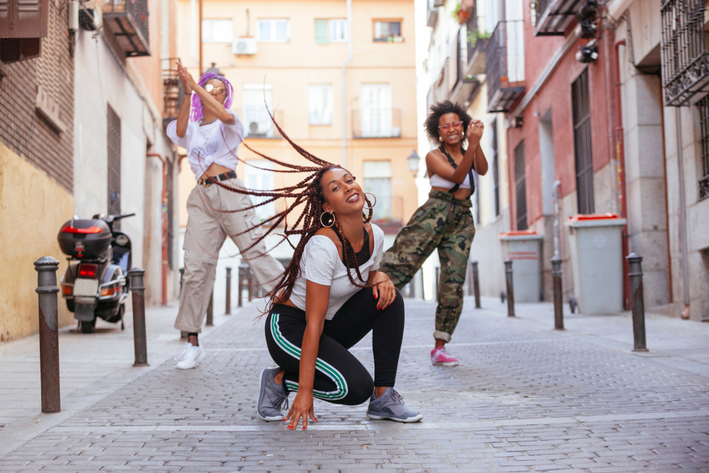 Three friends practicing a step dancing routine