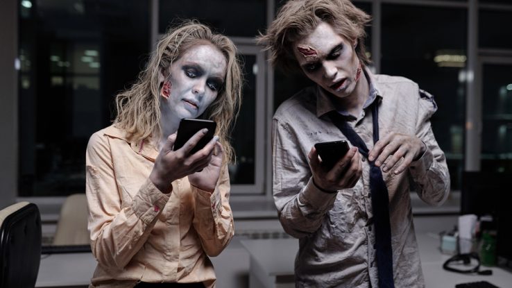 Two zombies using smartphones to find zombie team names