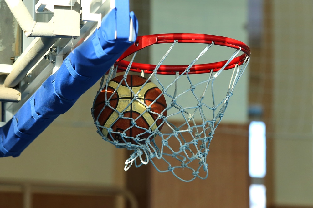 Basketball entering the net at a pro-am game