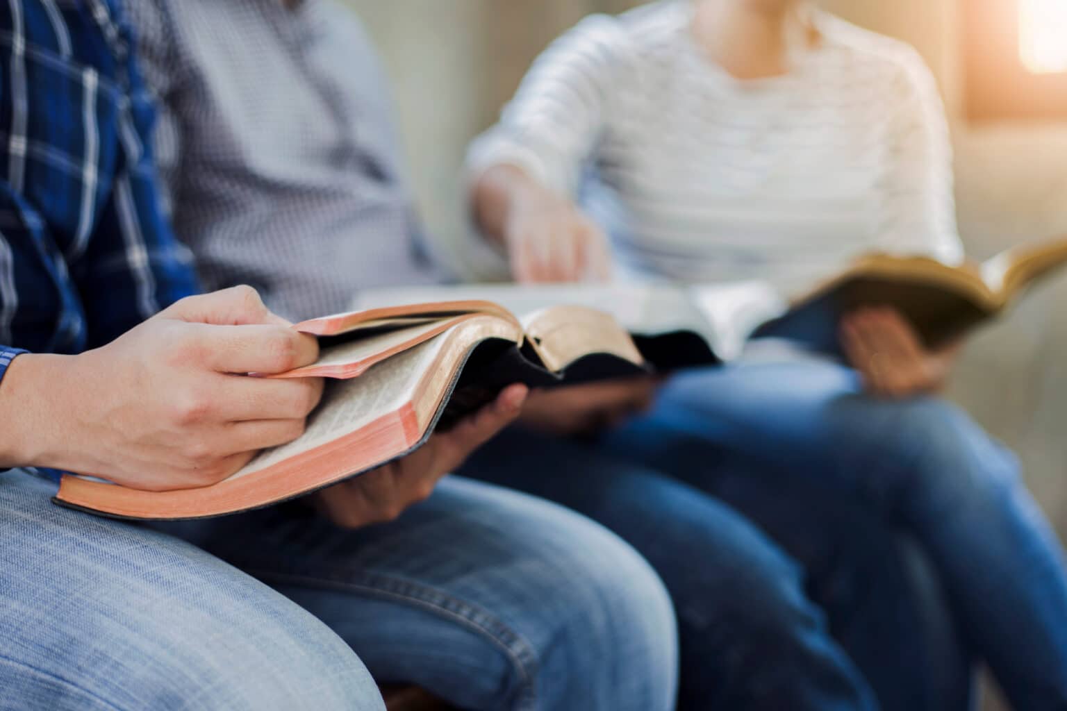 Close-up of people reading their bibles at a young adult ministry meeting