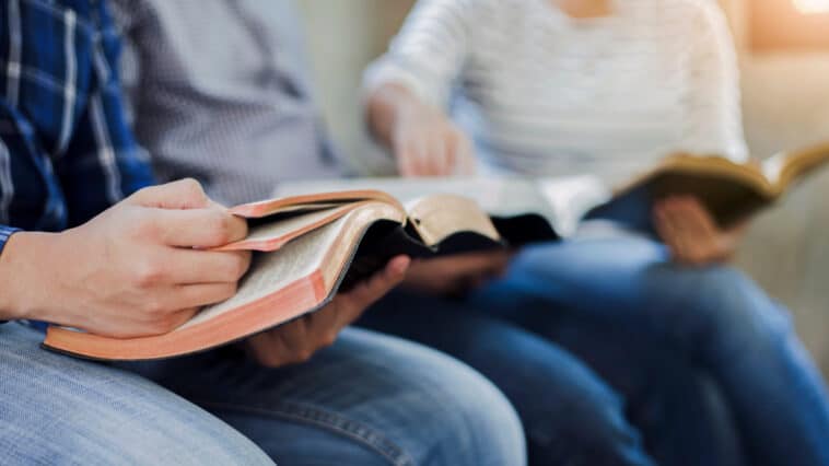Close-up of people reading their bibles at a young adult ministry meeting